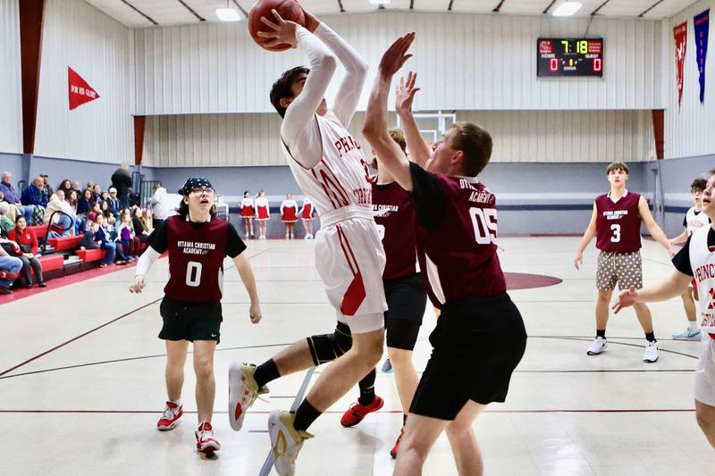 Princeton Christian Academy's Jed Johns shoots over Ottawa Christian Academy's Joseph Jameson Tuesday at Howard Hoffman Memorial Gym. The Eagles won 57-42.