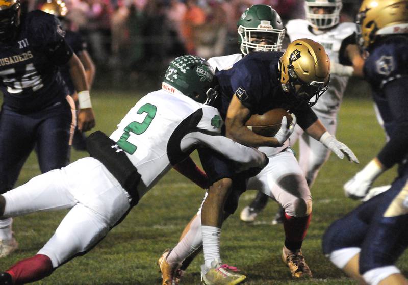Marquette's Payton Guiterrez is tackled by Seneca's Asher Hamby (2) at Gould Stadium on Friday, Oct. 6, 2023.