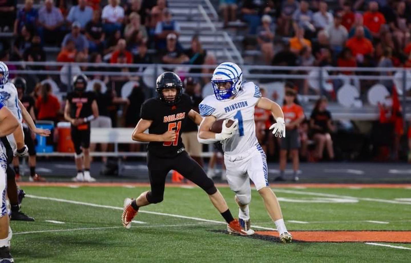 Princeton's Casey Etheridge runs past  Kewanee's Joey Janey Friday night at Kewanee. The Tigers won 44-15.