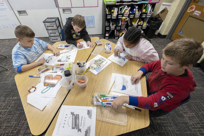 Students color in pictures for the Valor Support Project Monday, Nov. 10, 2025, at Merrill School in Rock Falls. The project helps raise money and awareness for veterans in need.
