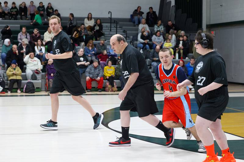 River Valley Special Rec player Eli Rorem returns to defense alongside teammates Britney Craft-Wills, right, and Shane Holdosh, left, in their game against Lincolnway Special Recreation Association at Bishop McNamara on Friday, Jan. 30, 2026.
