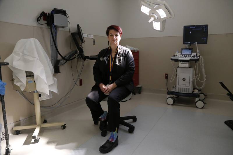 FILE - Dr. Colleen McNicholas, chief medical officer at Planned Parenthood of the St. Louis Region and Southwest Missouri, sits in a surgical room on April 11, 2022, at the Planned Parenthood clinic in Fairview Heights, Ill. Midwestern Planned Parenthood officials on Monday, Oct. 3, 2022, announced plans for a mobile abortion clinic — a 37-foot RV that will stay in Illinois but travel to near the border of adjoining states that have banned the procedure since the Supreme Court overturned Roe v. Wade earlier this year. (AP Photo/Martha Irvine, File)