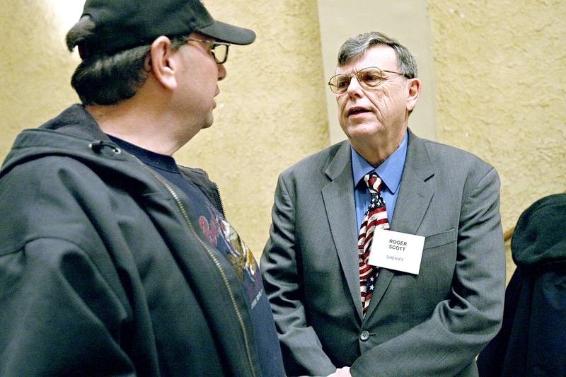 Sheriff Roger Scott (left) listens to John Zingale's concerns at a meet and greet during the DeKalb Chamber of Commerce's Candidates' Night at the Egyptian Theatre in DeKalb, Ill. on Tuesday January 19, 2010.