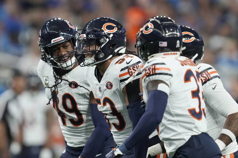 Chicago Bears linebacker T.J. Edwards (53) runs off the field with teammates after intercepting a pass during the first half against the Detroit Lions, Sunday, Nov. 19, 2023, in Detroit.