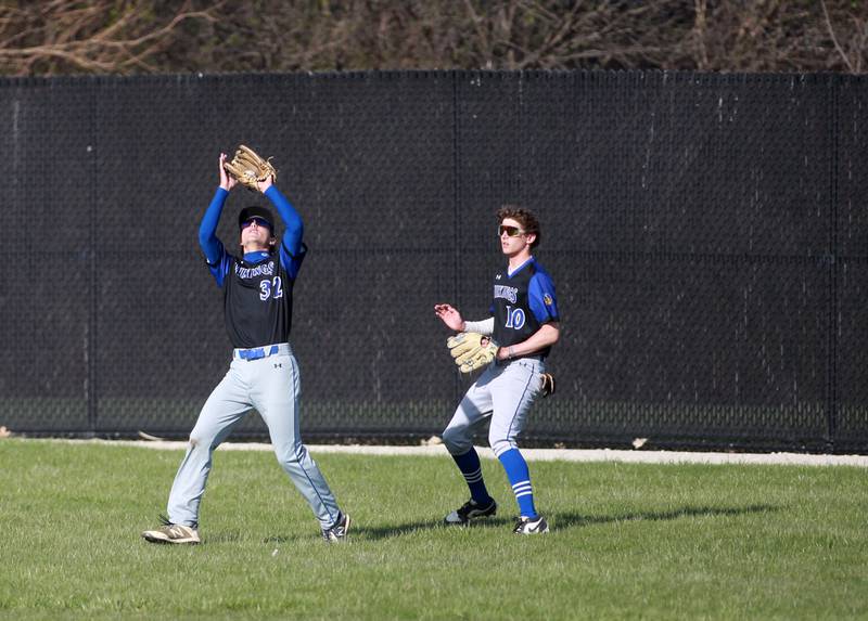 Geneva's Miles Dibble makes a catch in center field ahead of teammate Geneva's Josh Frieders during a game against Wheaton Warrenville South on Monday April 14, 2025 in Wheaton.