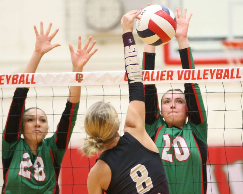 Morris's Ayla Phillips sends the ball in a different director as L-P's Ava Currie and teammate Anna Riva jump to attempt to block it on Thursday, Oct. 10, 2024 in A.J. Sellett Gymnasium at L-P High School.