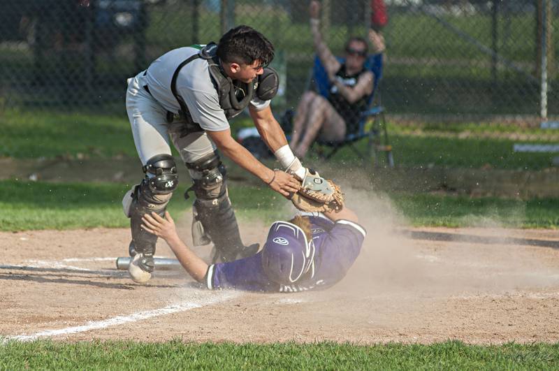 Dixon’s Mitchell White is tagged out at home against North Boone Thursday, May 12, 2022.