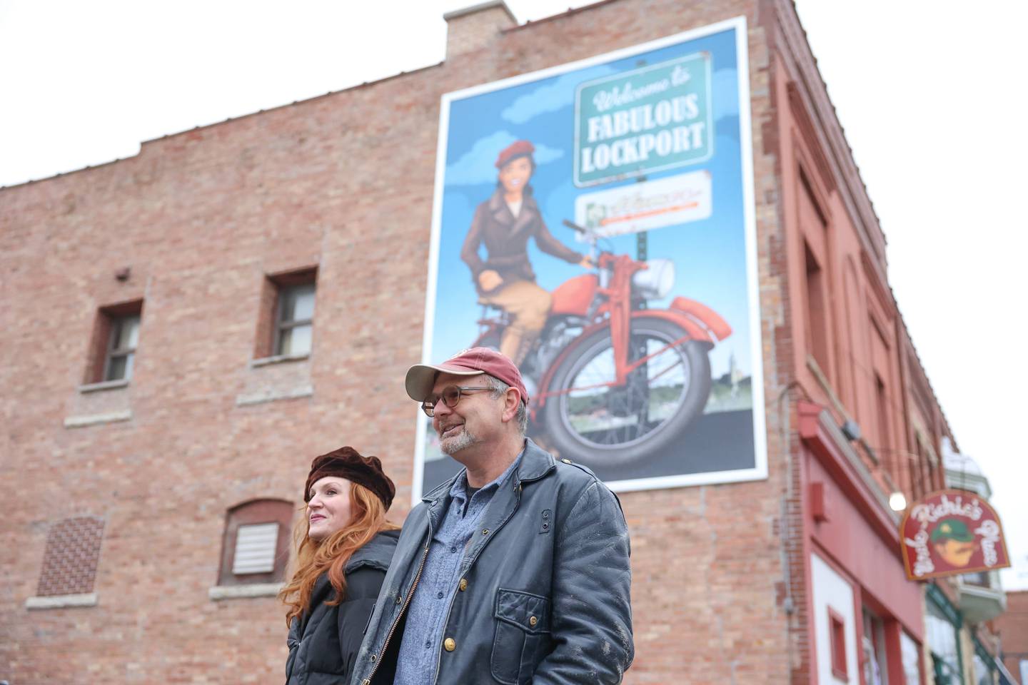 Wendy Streit, summer arts chair, stands with her husband Lockport Mayor Steve Streit at the newest mural on Saturday, Dec. 10, 2022, in Lockport.