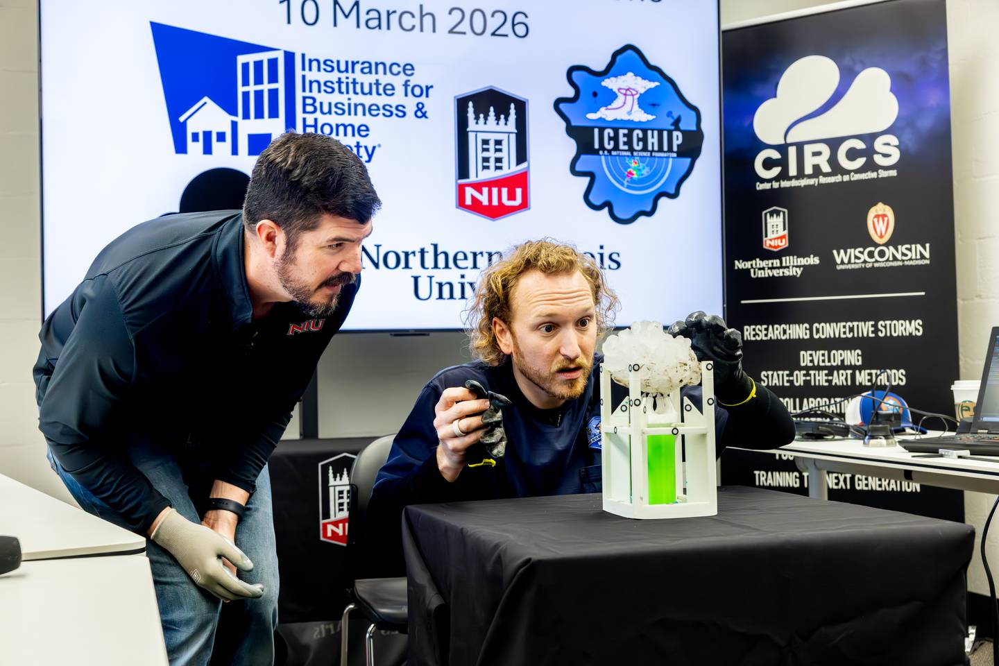 NIU professor and meteorologist Victor Gensini (left) and Lucas Faulkner of the Insurance Institute for Business and Home Safety, work together on Tuesday, March 17, 2026, in DeKalb, to measure a massive hailstone collected from a severe storm in Kankakee County on March 10, 2026. The stone was 6.6 inches wide and weighed nearly 20 ounces, likely a state record once certified, according to NIU.