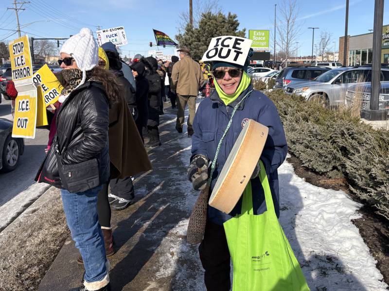 Judy Speer plays a drum during a protest in McHenry Feb. 1, 2026.