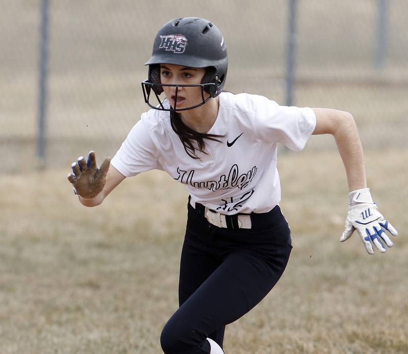 Huntley’s Katie Mitchell runs to home plate after the ball was overthrown as she slide into third base during a non-conference softball game Thursday March 17, 2022, between Huntley and Fremd at Huntley High School.