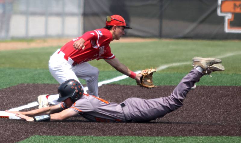 McHenry’s Jacob McConnell slides safely into third base as Barrington’s Jackson Roberts fields the throw in IHSA Class 4A Sectional Title Game baseball action at McHenry High School in McHenry on Saturday, June 7, 2025.
