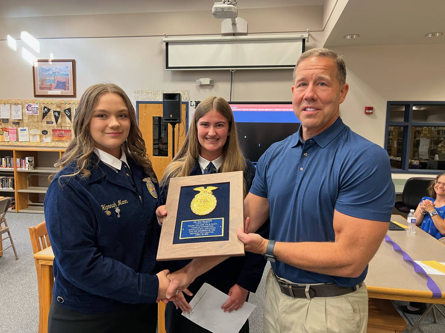 Hannah Mann, reporter (left) and Leah Stamberger, president (center) with the Mendota FFA present an appreciation plaque Tuesday, June 20, 2023, to Mendota High School Superintendent Jeff Prusator (right) for his continued support of agriculture.