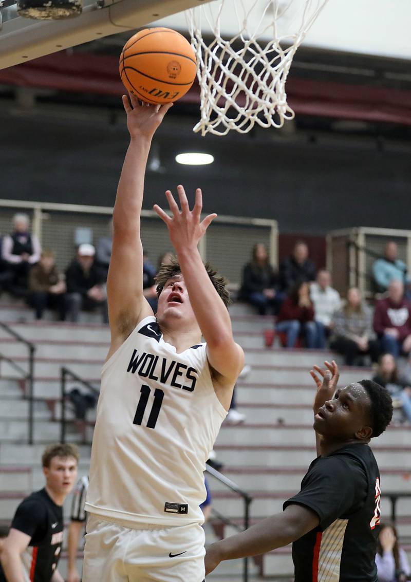 Prairie Ridge's Elijah Loeding shoots the ball in front of Huntley's Isaiah Onu during a Fox Valley Conference boys basketball game on Wednesday, Jan. 21, 2026, at Prairie Ridge High School in Crystal Lake.