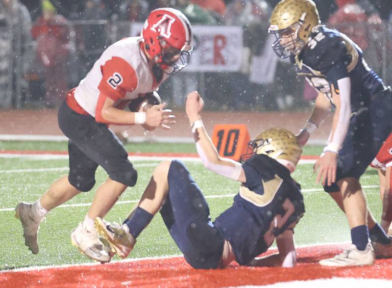 Amboy/LaMoille/Ohio's Caiden Heath, runs in for an extra point as Polo's Jt Stephenson falls to the turf during the 8-man I8FA championship game on Friday, Nov. 21, 2025 at April Zorn Memorial Stadium in Monmouth.