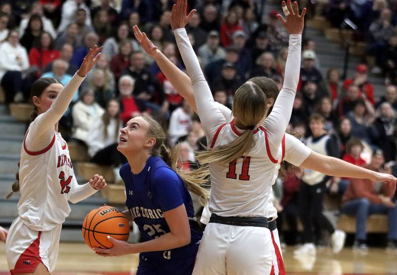 Lake Zurich’s Leah Gilbertson navigates heavy traffic in IHSA Class 4A Sectional girls basketball action on Tuesday, Feb. 25, 2025, at Huntley High School in Huntley.