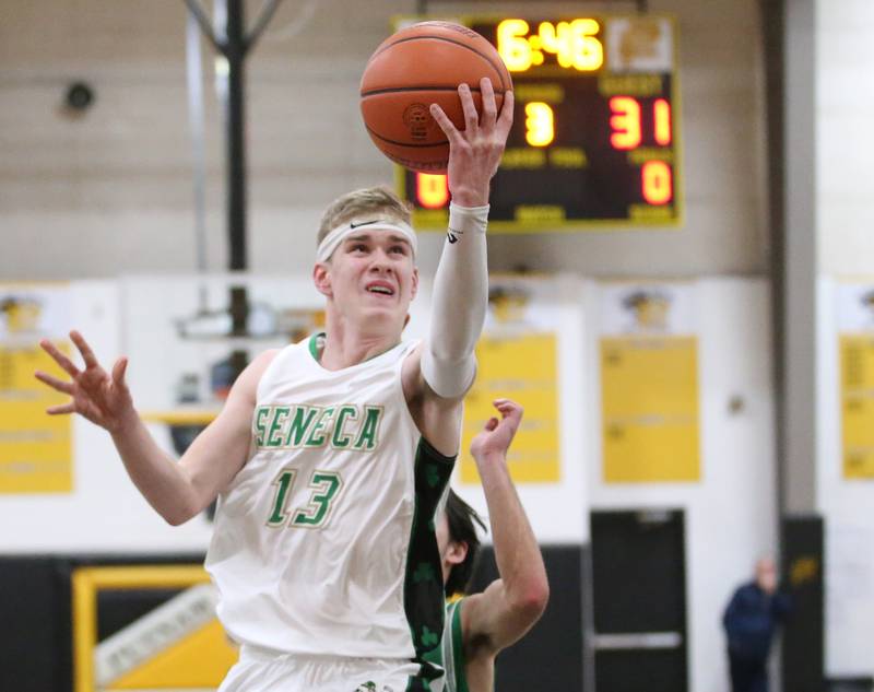 Seneca's Paxton Giertz runs in the lane past Dwight's Jack Duffy to score on a layup during the Tri-County Conference Tournament on Wednesday, Jan. 25, 2023 at Putnam County High School.