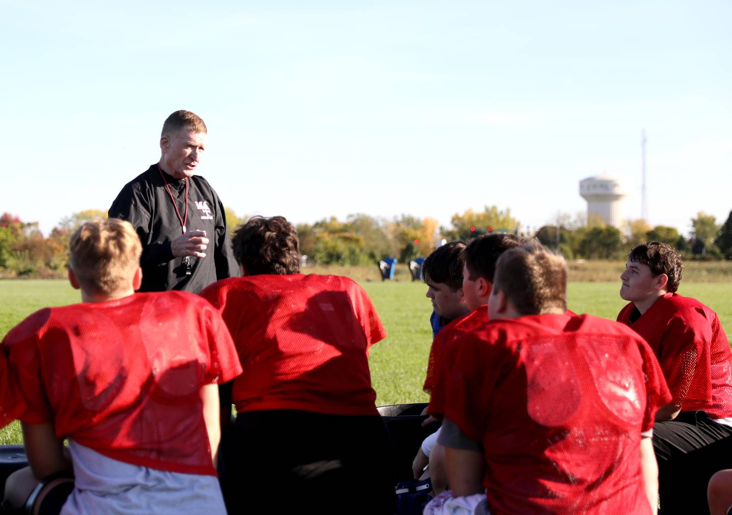 Former U.S. Marine Mark Placey works with the Marmion Academy football offensive line during a recent practice in Aurora.