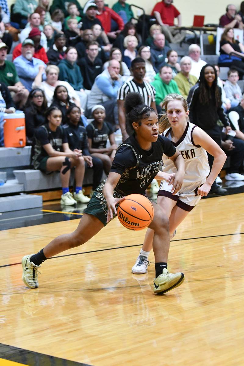 Bishop McNamara's Eliana Isom drives to the land against Watseka-Milford's Kami Muehling during the Fightin' Irish's 69-38 victory over Watseka-Milford in the IHSA Class 2A Herscher Sectional championship on Thursday, Feb. 27.