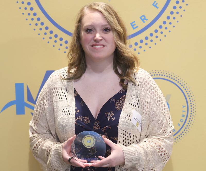 Ariel Swanson poses with her 40 Under Forty award during the Illinois Valley Chamber of Commerce Champions of Change Awards Night on Wednesday, May 6, 2026 at the Westclox Event Center in Peru.