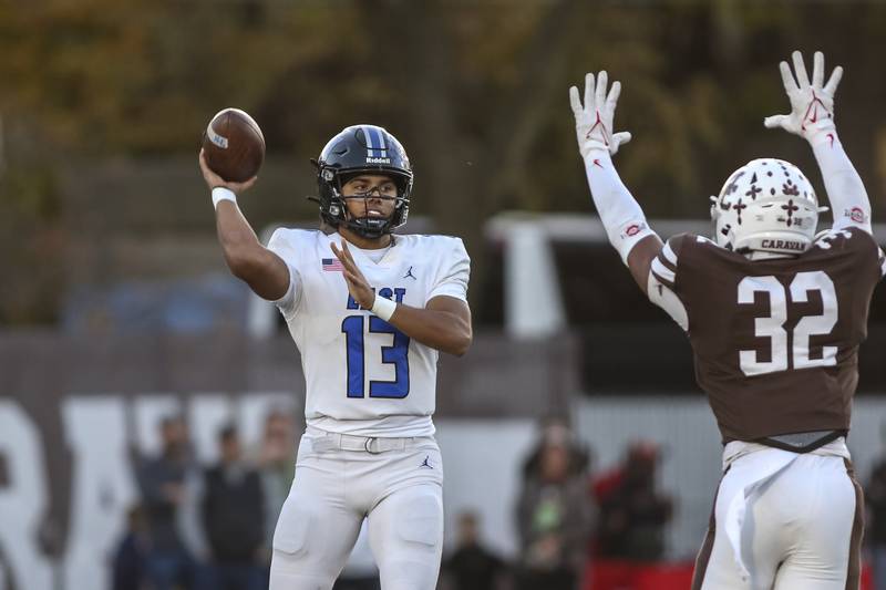 Lincoln-Way East's Jonas Williams (13) passes during Class 8A quarterfinal football game between Lincoln-Way East at Mount Carmel. Saturday, Nov 15, 2025 in Chicago.