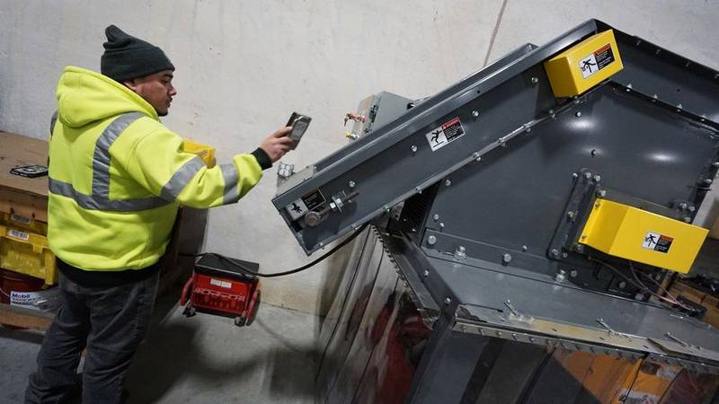 Elgin Recycling electronics manager Marco Valdez runs computer hard drives through an industrial shredder at the company's electronics recycling processing facility in West Dundee. Paul Valade | The Daily Herald