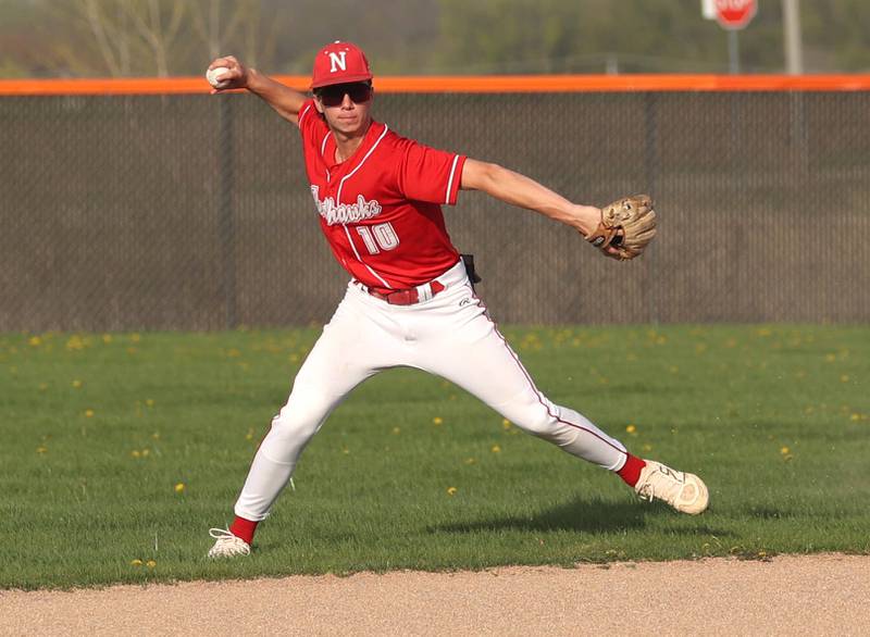 Naperville Central's Cooper Page throws to first Monday, April 28, 2025, during their game at DeKalb High School.