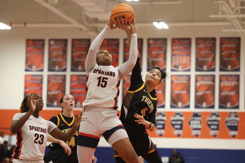 Romeoville’s Peyton Williams and Joliet West’s Grace Clayborn battle for the rebound on Thursday, Jan. 29, 2026 in Romeoville.