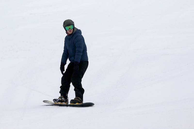 A snowboarder makes a run at Wilmot Mountain Ski Resort on Thursday, Jan. 16, 2025, in Wilmot, Wisconsin.
