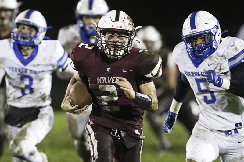 Prairie Ridge quarterback Mason Loucks runs the ball against Vernon Hills during their playoff football game at Prairie Ridge High School on Friday, Oct. 29, 2021 in Crystal Lake.