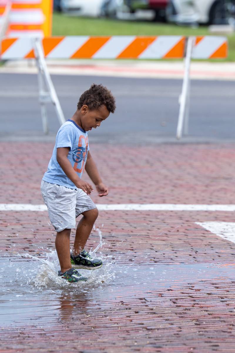 Grayson Rapp jumps in puddle during the annual Shrimp Fest on Saturday, June 7, 2025 at Rotary Park in Princeton.