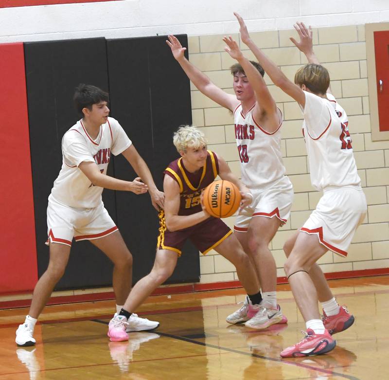 Oregon's Nole Campos (13), Keaton Salsbury (10), and Brian Wallace (15) trap Stockton's Wyatt Record on Saturday, Dec. 13 at the 64th Annual Forreston Holiday Basketball Tournament held at Forreston High School.