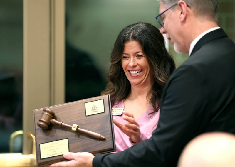 Tia Anderson, outgoing board chair, accepts a plaque from Chamber Executive Director Matt Duffy in appreciation for her work during her time as chair Thursday, Feb. 8, 2024, during the DeKalb Chamber of Commerce’s Annual Celebration Dinner in the Barsema Alumni and Visitors Center at Northern Illinois University.