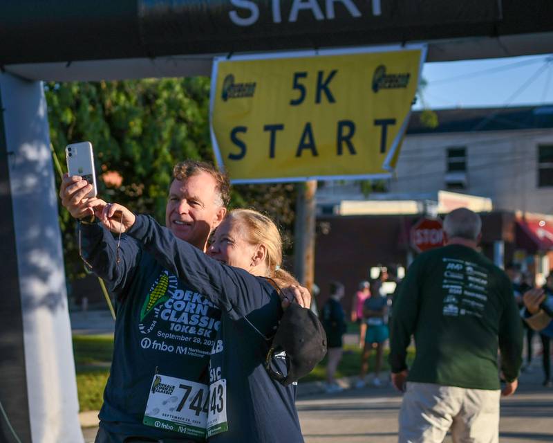 Brendan Wilson and his wife Kay Wilson of DeKalb take a selfie together on Sunday, Sept. 29, 2024, before the start of the the DeKalb 5K/10K Corn Classic race held in downtown Dekalb.