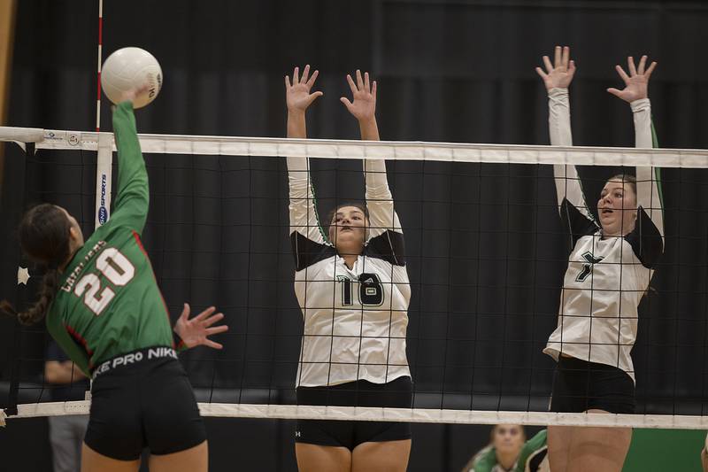 Rock Falls’ Ari Reyna (left) and Addison Miller go up to block a shot by Lasalle-Peru’s Anna Riva Wednesday, Sept. 4, 2024, at Rock Falls High School.