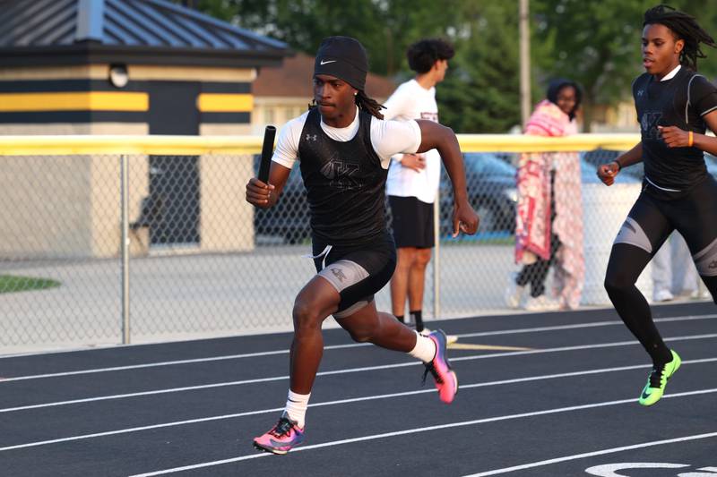 Kankakee's Kymani Billings accelerates after the handoff from Dominic White during the 4x200 relay race at the Herscher Track Invite on Friday, May 1, 2026.