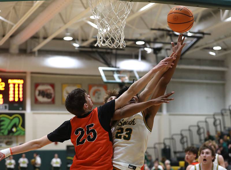 Crystal Lake South's David Mcfadden (right)  fights to get a shot up against Crystal Lake Central's Aidan Watson during an IHSA Class 3A Crystal Lake South Regional boys basketball semifinal game on Wednesday, February, 25, 2026, at Crystal Lake South High School.