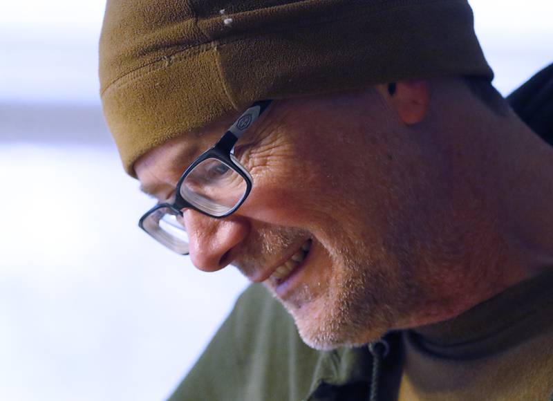 Veteran Craig Taylor watches as Tom Powers and Jerry Webb, from Home Depot, install new cabinets in Taylor's home on Thursday Jan. 16, 2025. The kitchen remodel for Taylor is part of the 30 Days for 30 Vets program.