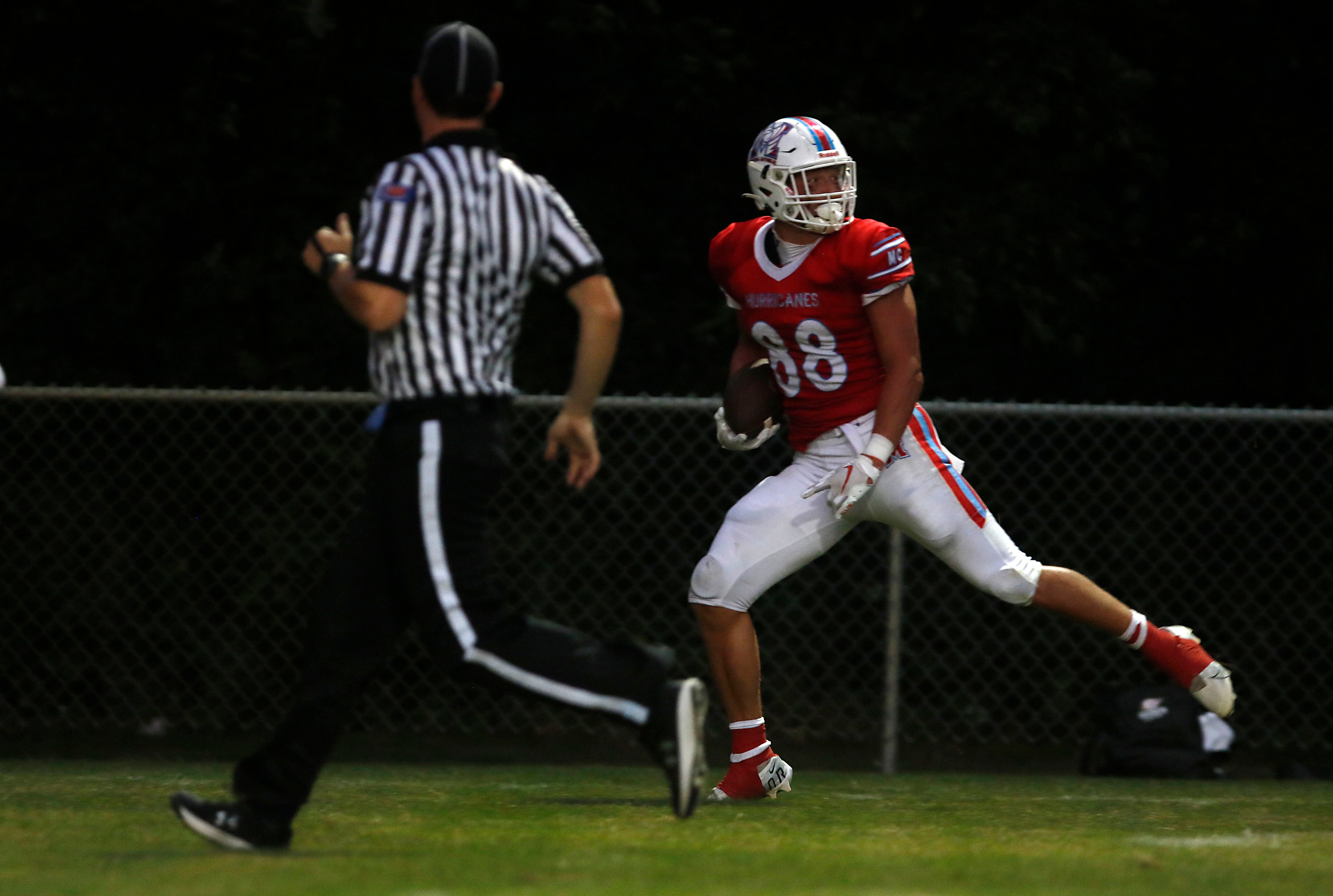 Marian Central's Christian Bentancur looks back as he runs for a touchdown during a nonconference football game against Marian Central Friday, Aug. 25, 2023, at Marian Central Catholic High School.