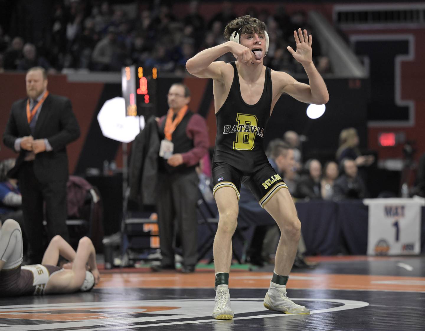 Batavia’s Kai Enos reacts for the crowd after defeating Morris’ Paxton Valentine’s in the Class 120-pound bout at the boys IHSA wrestling finals at State Farm Center in Champaign on Saturday, Feb. 21, 2026.