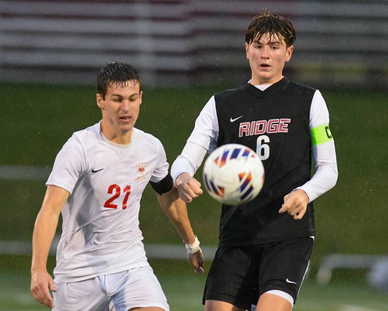 Benet Academy's Brendan Bergnach (21) and Prairie Ridge's Matthew Rireng (6) battle for the ball during the class 2A super sectional soccer match on Tuesday Nov. 5, 2024, held at Wheaton Academy in West Chicago.