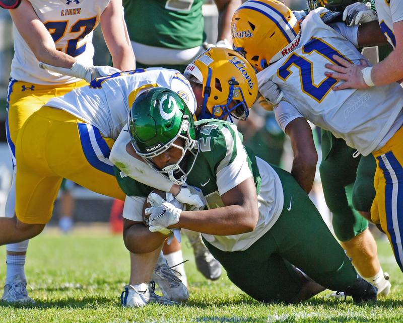 Glenbard West’s fullback Amari Harris (24) drives for a first down during a game against Lyons Township on September 27, 2025 at Glenbard West High School in Glen Ellyn.