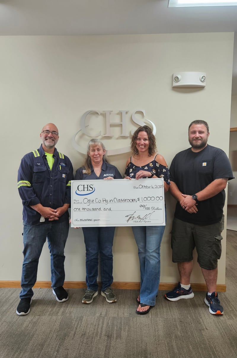 Ag in the Classroom Program Coordinator Melinda Colbert accepts CHS Rochelle's donation check. From left to right: Mark Zaccaria, CHS; Melinda Colbert, U of I Extension AITC program coordinator; Samantha Zaccaria, CHS; and Josh Brandau, CHS.