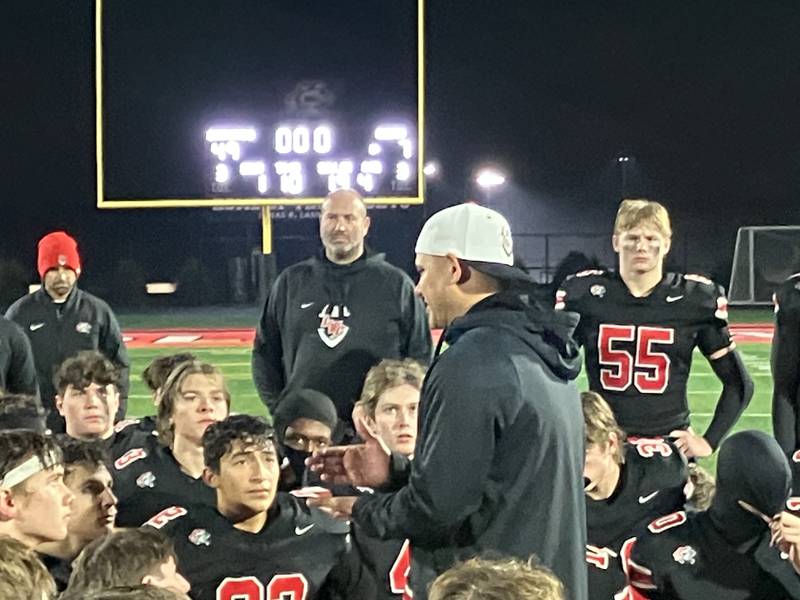 Lincoln-Way Central coach Dave Woodbury addresses his players following the Knights’ 49-7 opening-round playoff victory.