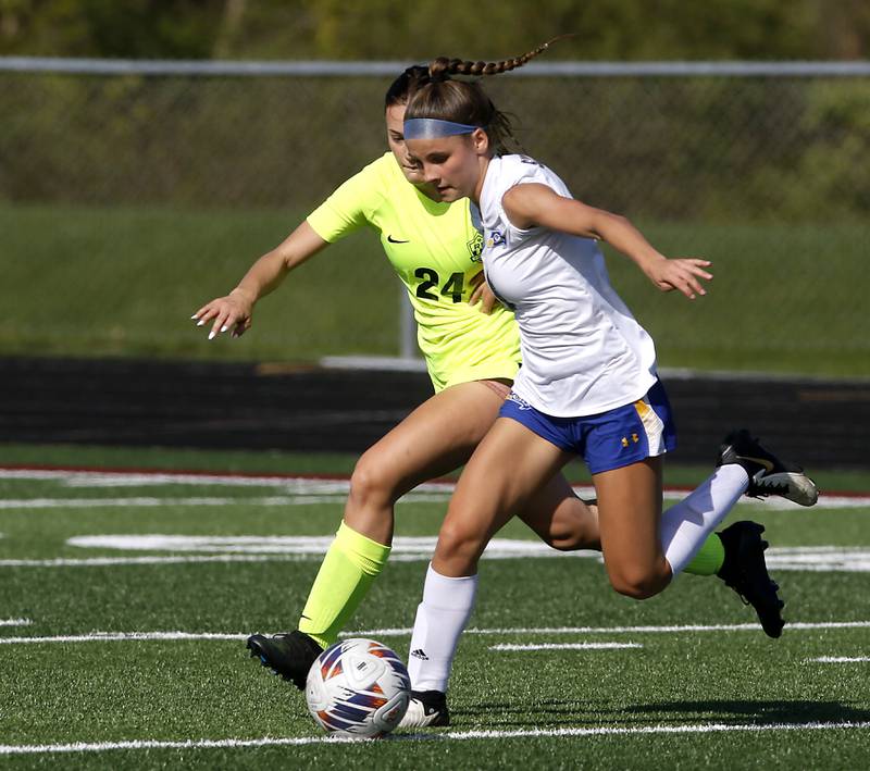 Richmond-Burton's Ember Demers applies pressure to Johnsburg's Elizabeth Smith as she makes a run towards the goal during the Kishwaukee River Conference Girls Soccer Tournament Championship Match on Wednesday, May 1, 2024, at Richmond-Burton High School.