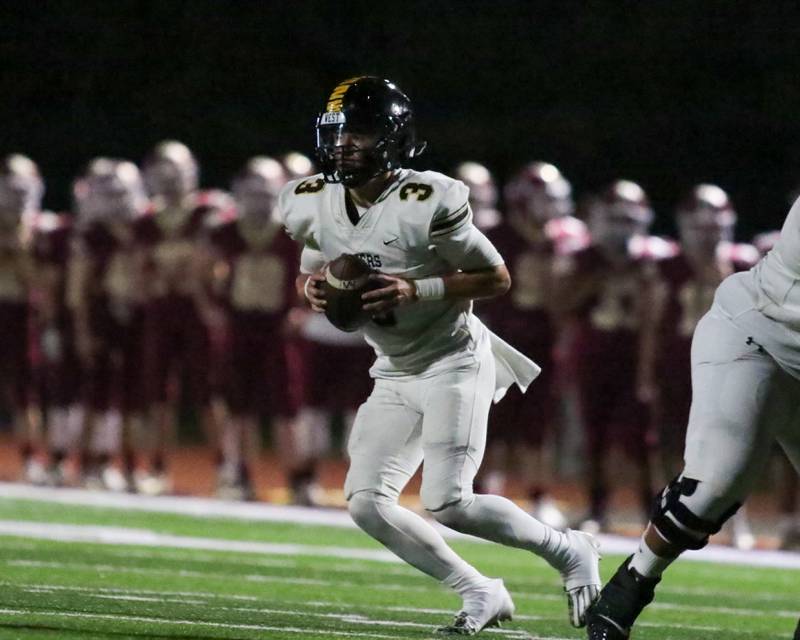 Joliet West's Juan Rico (3) drops back to pass during football game between Joliet West at Morris.  Sept 1, 2023.