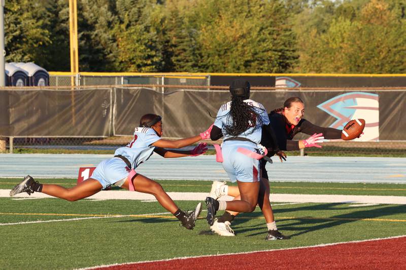 Yorkville's Kayla Kersting reaches out to score a touchdown as Kankakee's Jasyia Wesby, left, and London Stroud attempt to stop her during the Foxes' 26-13 victory over Kankakee on Tuesday, Oct. 7, 2025.