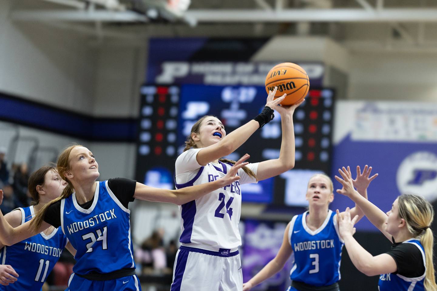 Plano's Chloe Rowe (24) puts up a shot while being defended by Woodstock's Aiyana Fourdyce during Monday's game in Plano.