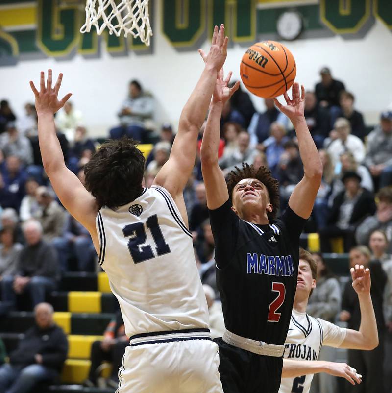 Marmion's Caden Anderson tries to get a shot off in front of Cary-Grove's Brady Elbert during an IHSA Class 3A Crystal Lake South Regional boys basketball semifinal game on Wednesday, February, 25, 2026, at Crystal Lake South High School.