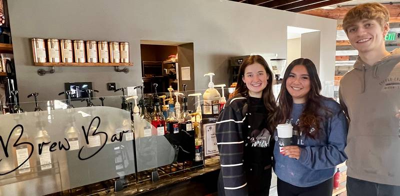 Left to right: Baristas Ashley Diehl, Janelle Gomez and Alex Van Sickle stand in front of the Brew Bar at Coffee Crush in Dixon.
